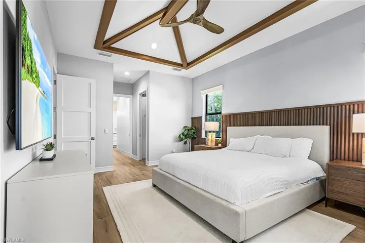 Bedroom with wood finished floors, ceiling fan, and recessed lighting