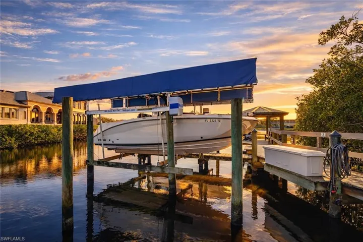 Dock with boat lift and a water view