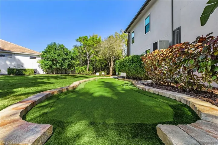 View of yard featuring a putting green and a patio