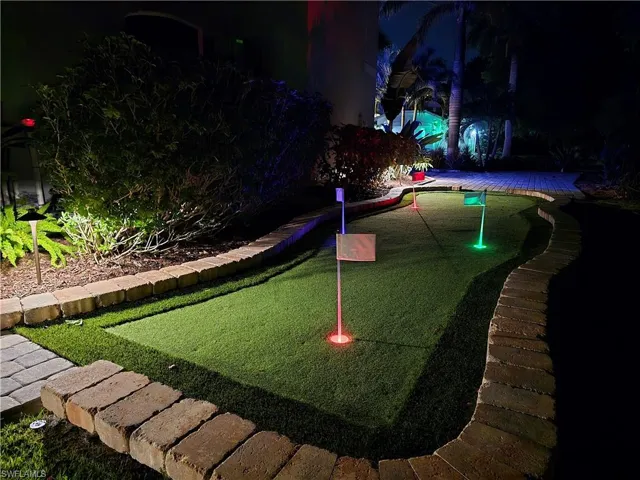 View of home's community featuring an area to practice putting