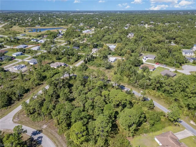Aerial view of property's location with nearby suburban area and a large body of water