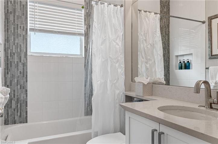 Bath for 3rd bedroom closed off with barn door