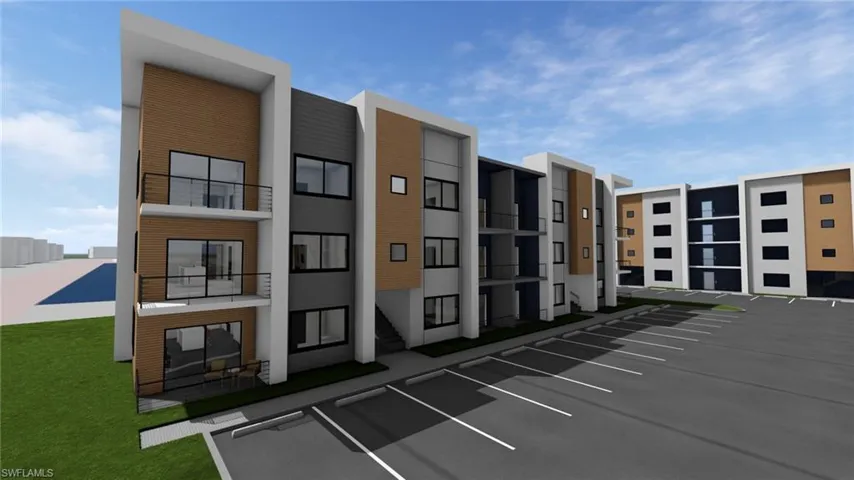 View of apartment building / complex with uncovered parking