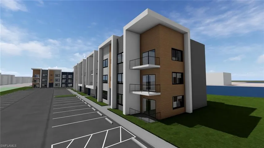 View of apartment building / complex with uncovered parking