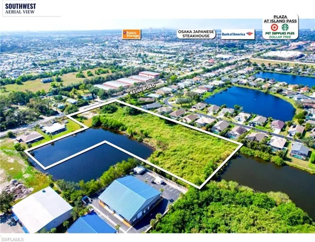 Aerial perspective of suburban area with property boundaries highlighted and a nearby body of water