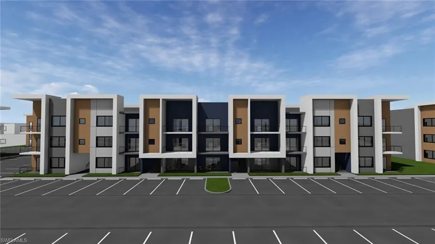 View of building exterior featuring uncovered parking