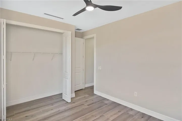 Light gray wood-finish flooring complements neutral wall tones in this interior space