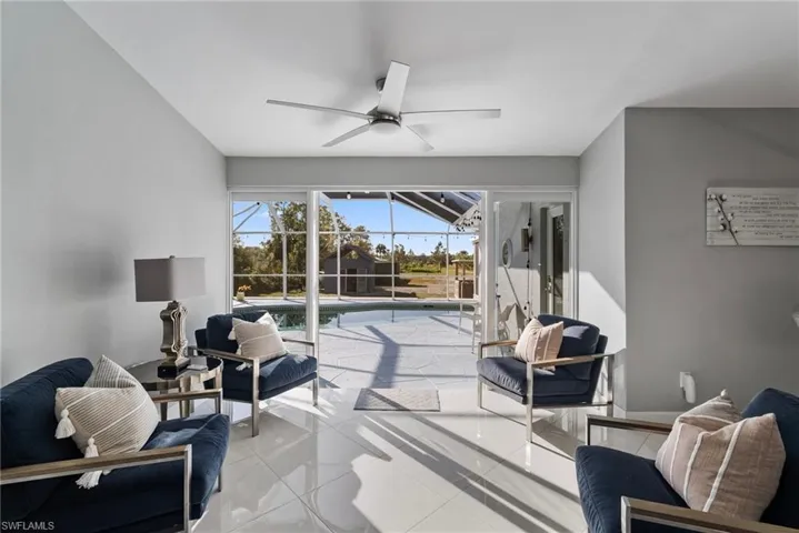 Sunroom with ceiling fan and a pool