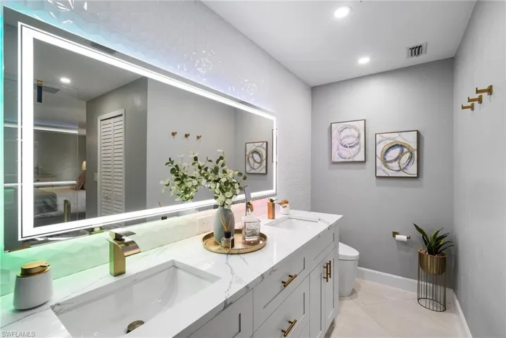 Bathroom with tile patterned floors, vanity, and toilet