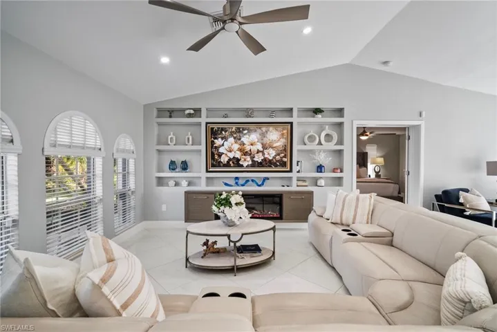 Tiled living room with built in features and lofted ceiling