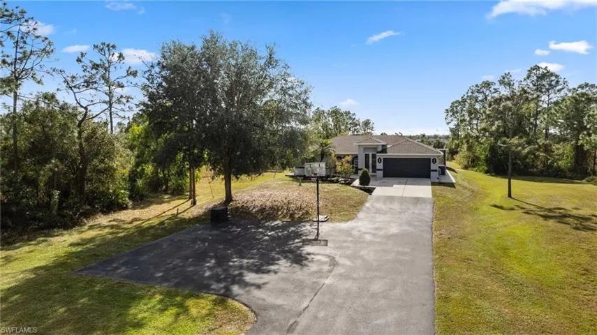 View of front of home featuring a front yard and a garage