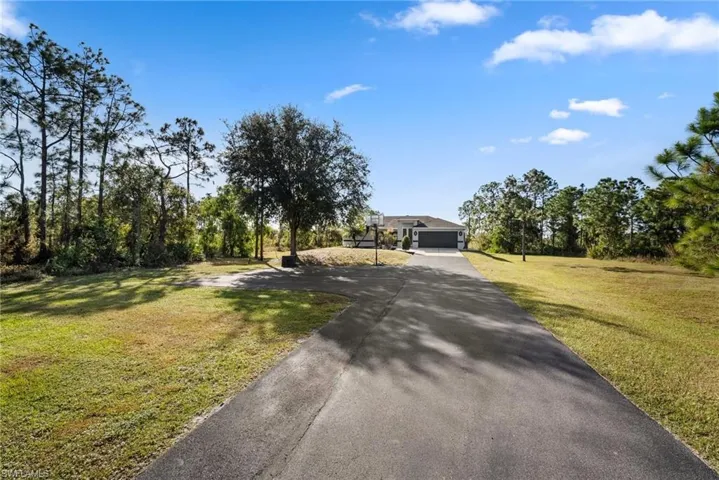 View of front of home with a garage and a front yard