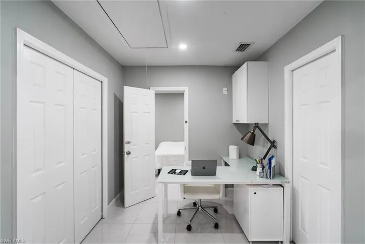 Office area with light tile patterned floors