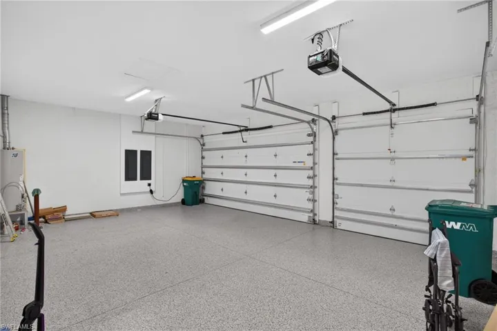 Two-car garage featuring automatic garage door openers and epoxy flooring