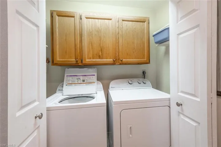 Clothes washing area with cabinets and washing machine and dryer