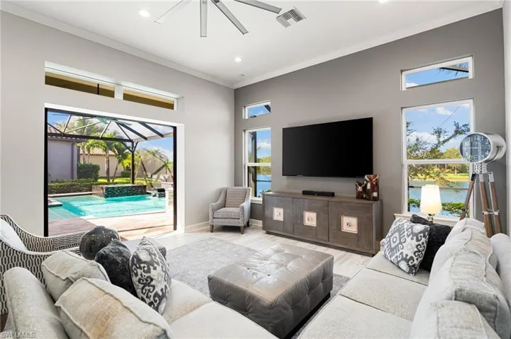 Living room featuring a sunroom, crown molding, wood finished floors, ceiling fan, and recessed lighting