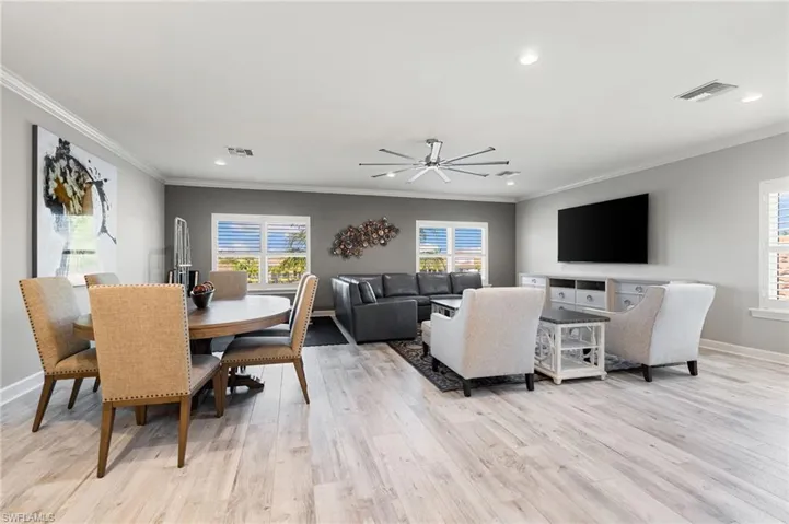 Dining area featuring recessed lighting, plenty of natural light, crown molding, light wood-type flooring, and a ceiling fan