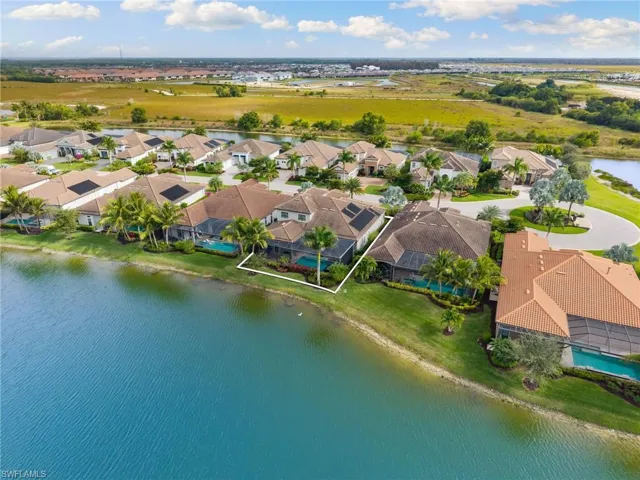 Aerial perspective of suburban area with a nearby body of water