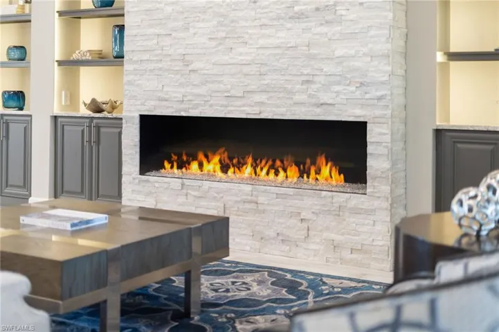 Living area featuring a stone fireplace