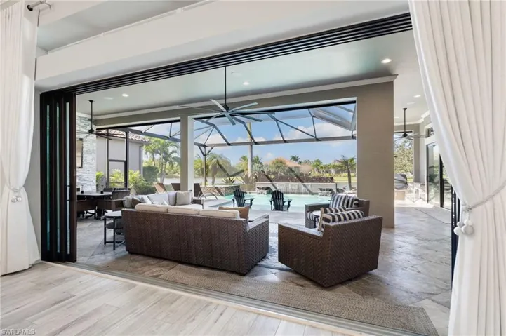 Building lobby featuring a sunroom, crown molding, and recessed lighting