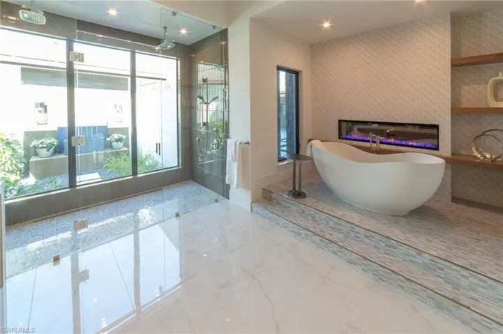 Bathing sanctuary with a free-standing tub and fireplace