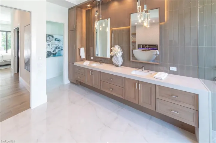 Bathroom with vanity, tile walls, and backsplash