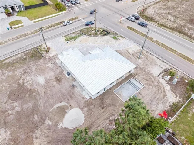 The property features a newly constructed residence with a light-colored metal roof and a dedicated area for a swimming pool