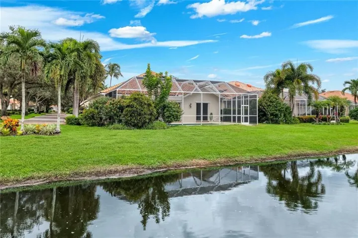 Expansive green lawn bordering a reflective body of water