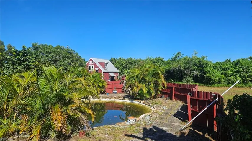 View of yard with a small pond