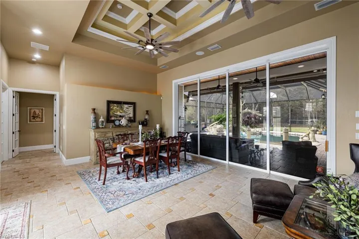 Dining room with a sunroom, coffered ceiling, recessed lighting, and ceiling fan