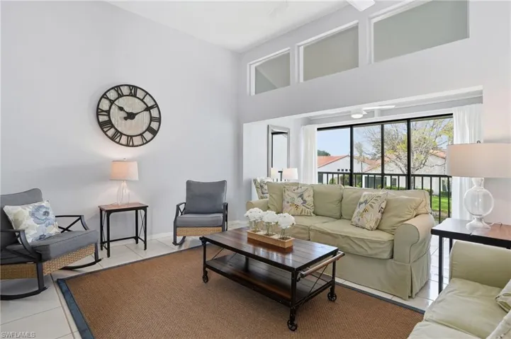 Living area featuring high vaulted ceilings and transom windows