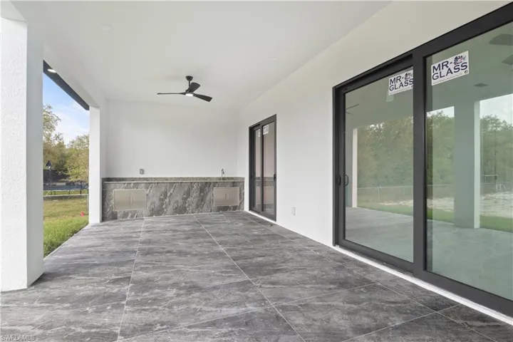 Unfurnished sunroom with ceiling fan