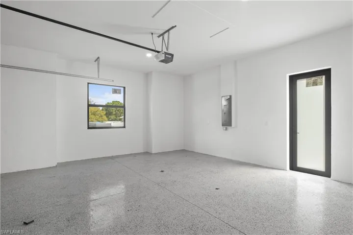 Garage with electric panel and a garage door opener