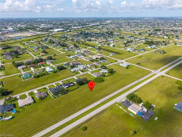 Aerial view of property's location featuring nearby suburban area