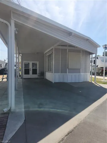 Front view with carport and florida room space.