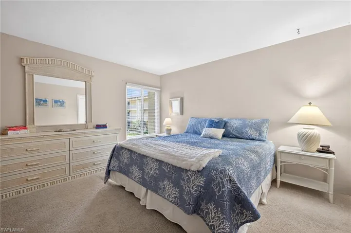 Large primary bedroom with King bed, side tables & dresser