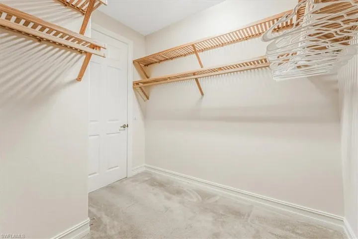 Walk in closet featuring carpet flooring
