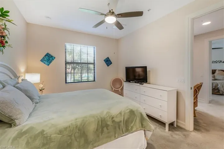 Bedroom with light colored carpet and ceiling fan