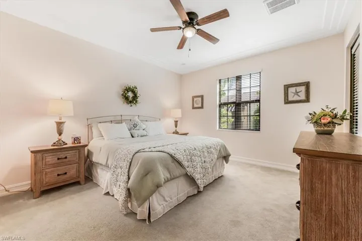 Bedroom with light carpet and ceiling fan