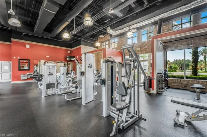 Exercise room with a towering ceiling
