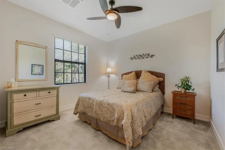 Bedroom with light colored carpet and ceiling fan