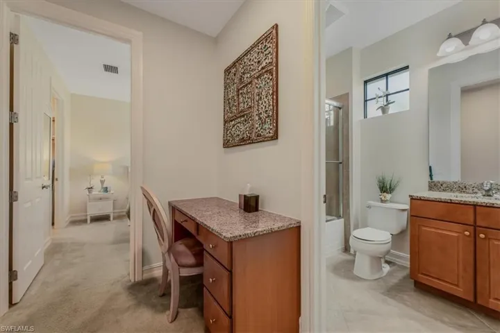 Bathroom featuring vanity and bath / shower combo with glass door