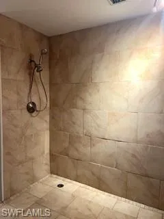 Bathroom featuring a tile shower
