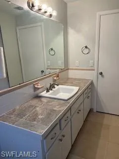 Bathroom featuring vanity and tile patterned flooring