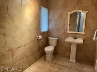 Bathroom with toilet and tile patterned floors