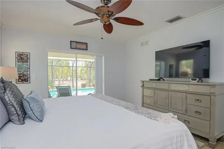 Slider from bedroom leads to lanai and pool