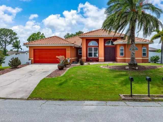Mediterranean / spanish home with a garage and a front yard