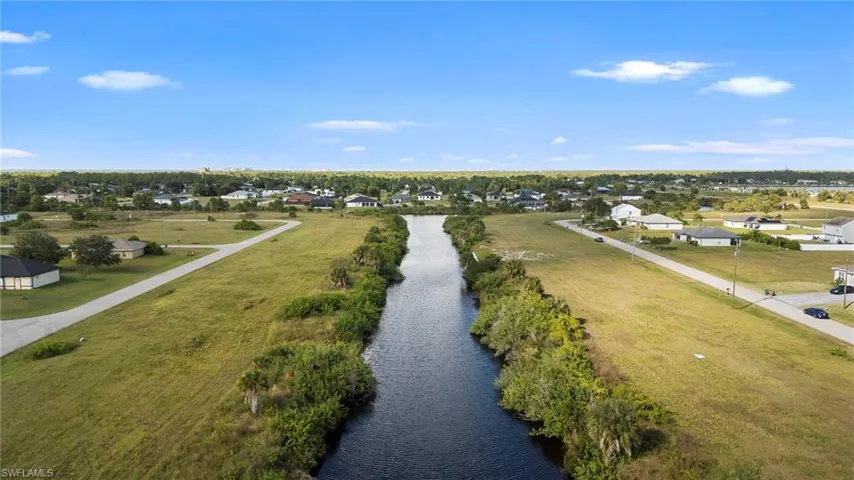 Aerial view of residential area featuring a nearby body of water