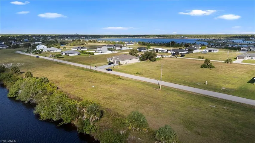 Aerial perspective of suburban area with a nearby body of water
