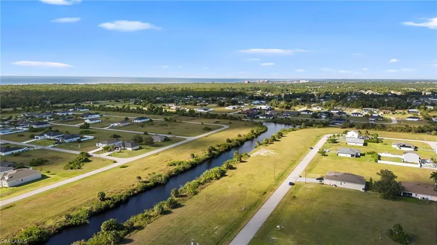 Aerial view of residential area featuring a large body of water